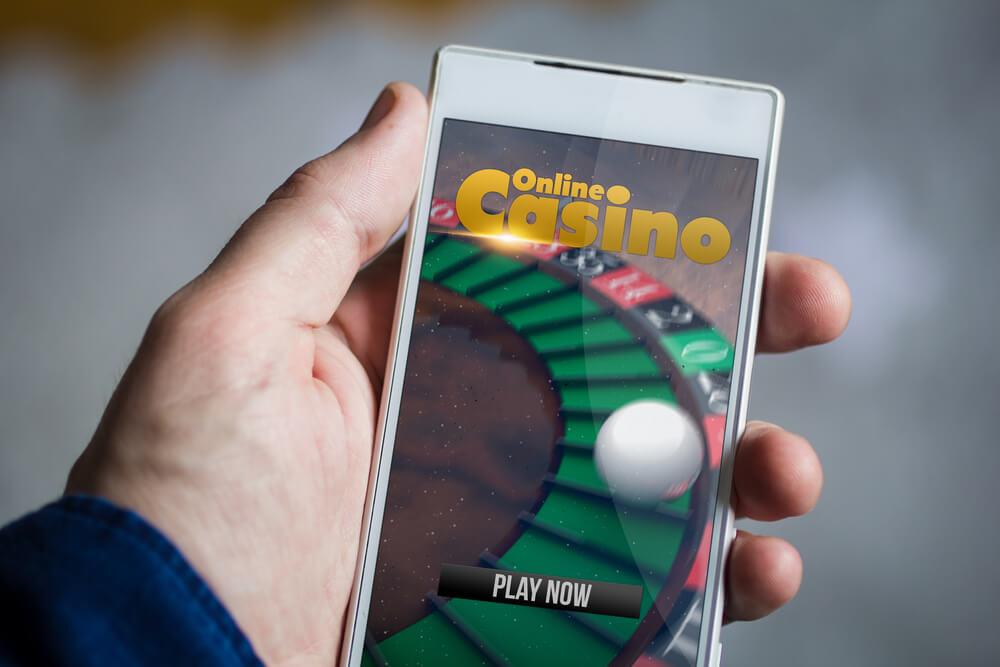 man hand holding online casino smartphone