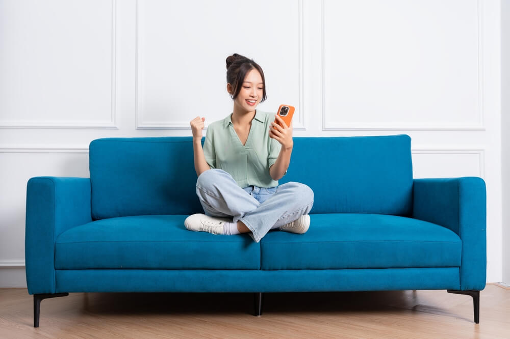 image of young girl sitting on sofa at home