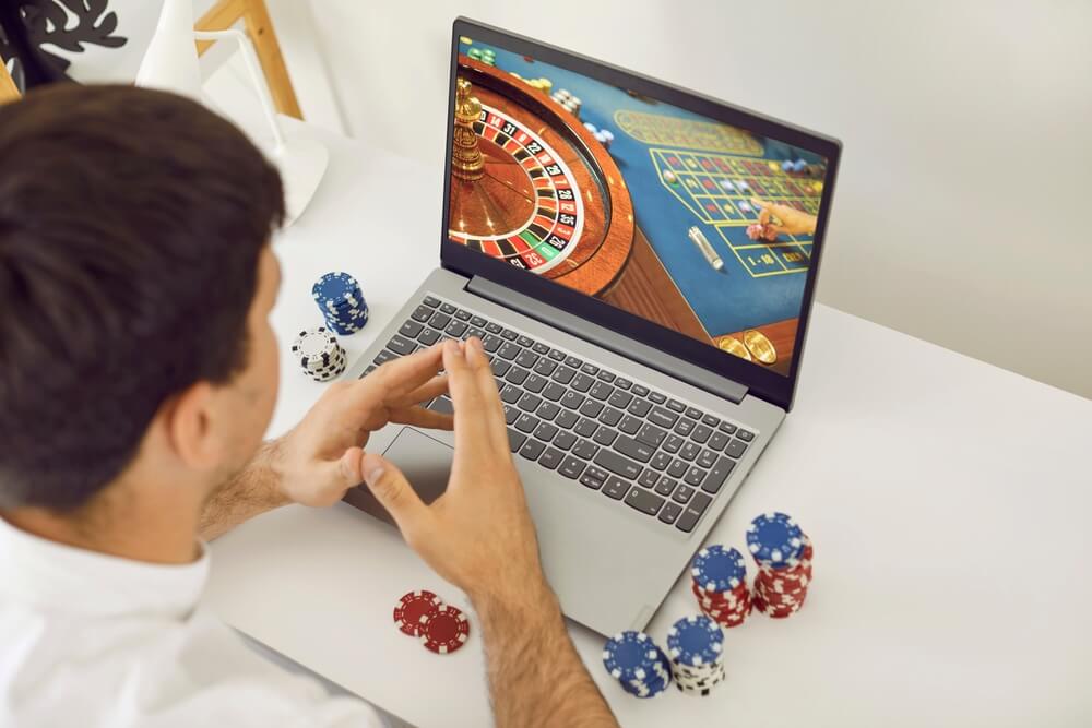 Young man playing poker on an online casino club website